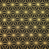 Close-up shot of black Japanese cotton fabric with a gold foiled geometric star motif.