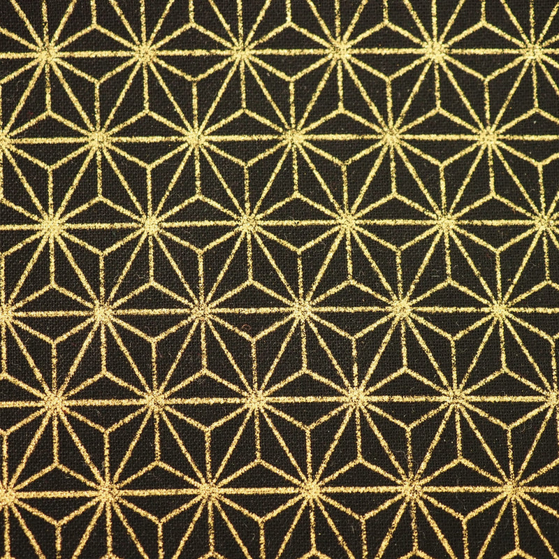 Close-up shot of black Japanese cotton fabric with a gold foiled geometric star motif.