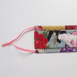 Rectangular two-fold barrier face mask with a Japanese geisha print and pink adjutsable elastics laid flat on a white background